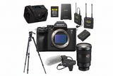 Sony camera with accessories including a lens, microphone, and battery on a white background